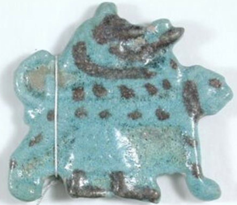 Blue/black glaze Anubis attending a mummy on its bier Blue/black glaze Anubis attending a mummy on its bier