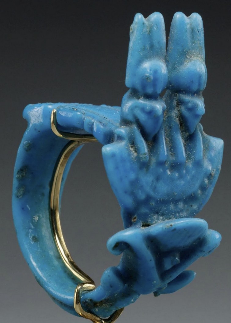Blue glazed ring with a double crowned Horus falcon aegis over a lotus flower Blue glazed ring with a double crowned Horus falcon aegis over a lotus flower