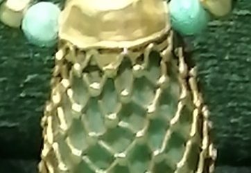 Pendant surrounded by a golden net
