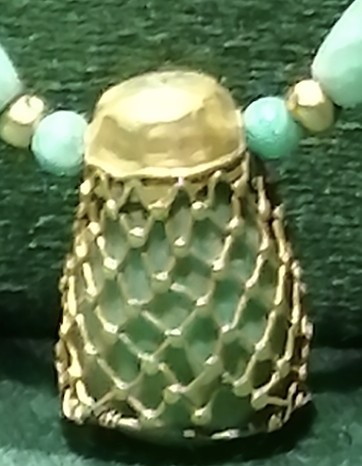 Collar pendant surrounded by a golden net