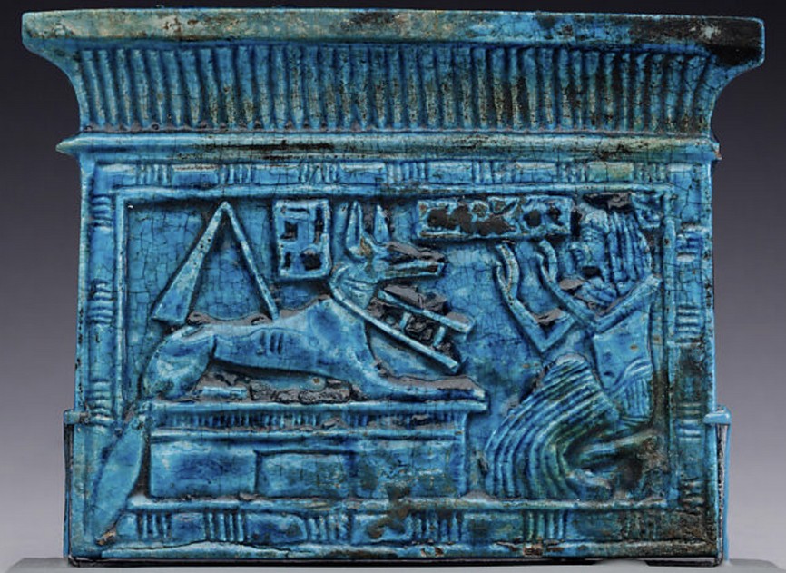 Glazed steatite with the owner workshipping Anubis and a djed pillar and Isis knots pylon shaped pectoral