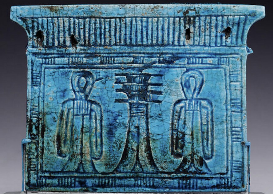 Glazed steatite with the owner workshipping Anubis and a djed pillar and Isis knots pylon shaped pectoral Glazed steatite with the owner workshipping Anubis and a djed pillar and Isis knots pylon shaped pectoral