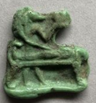 Green glass inlay of Anubis attending a mummy on its bier Green glass inlay of Anubis attending a mummy on its bier