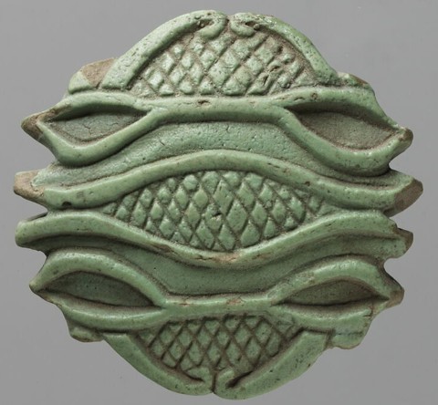 Green glaze partly broken with a single wedjat backwards