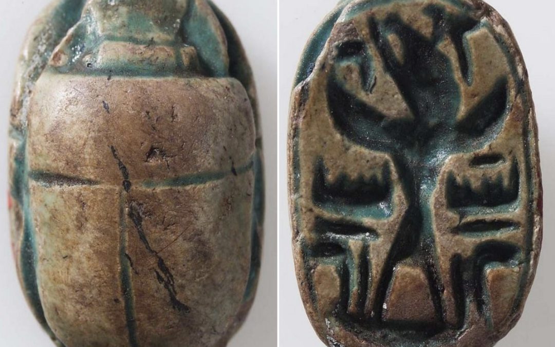 Faded dark green glazed steatite scarab with winged Baal