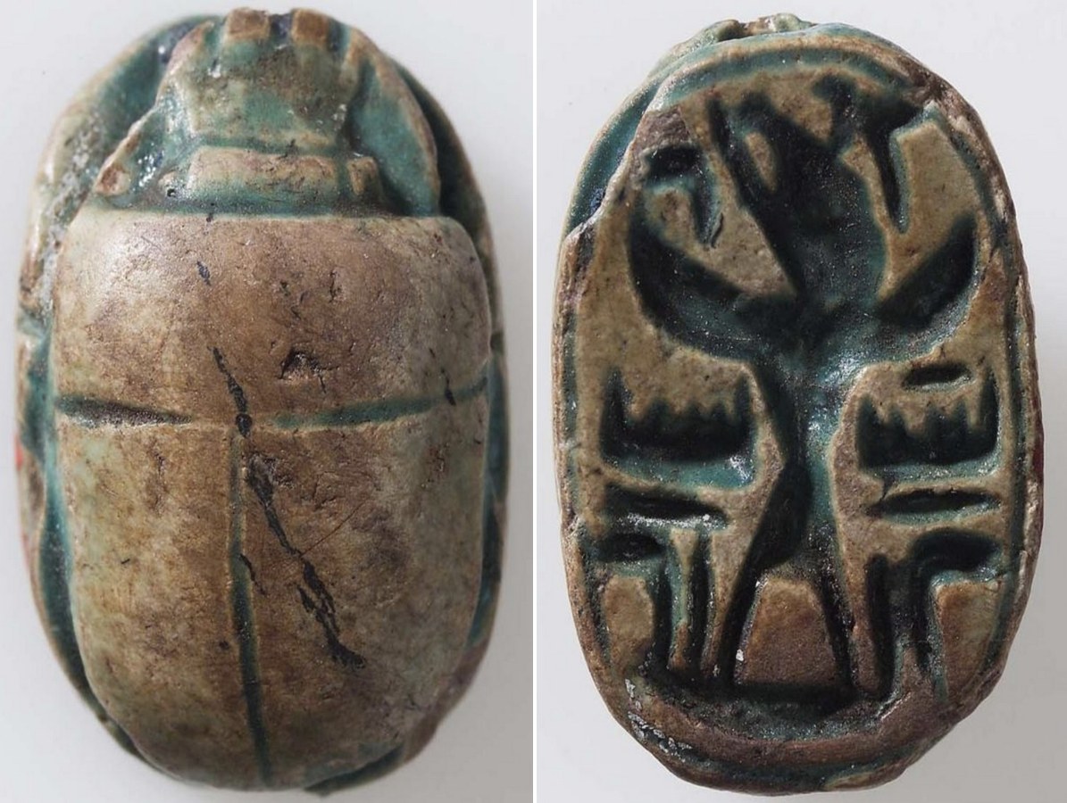 Faded dark green glazed steatite scarab with winged Baal Faded dark green glazed steatite scarab with winged Baal