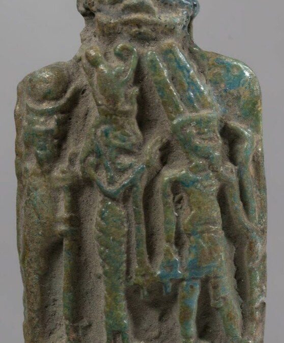 Green glazed plaque of the Theban triad with a Bes head