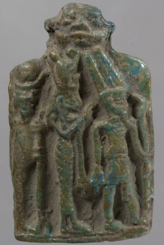 Green glazed plaque of the Theban triad with a Bes head Green glazed plaque of the Theban triad with a Bes head