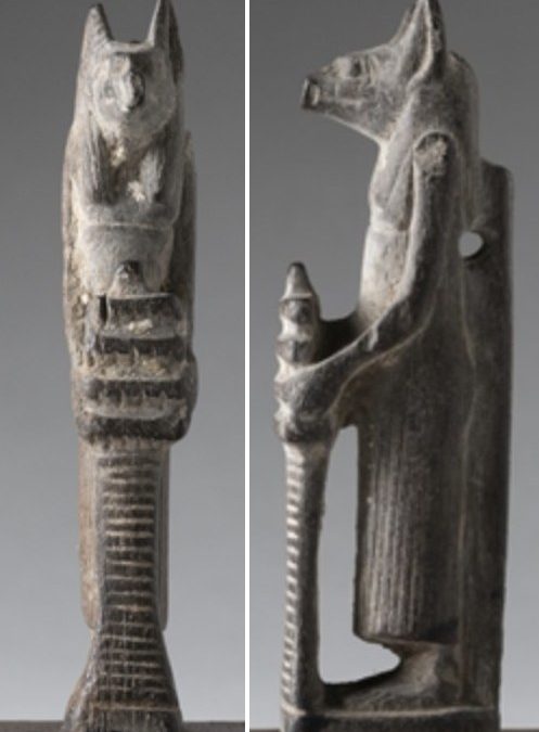 Wooden Anubis holding a djed pillar