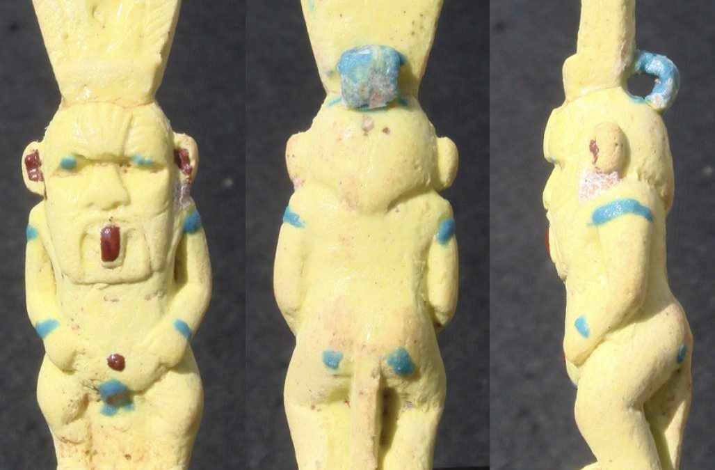 Yellow glaze Bes with red encrustations